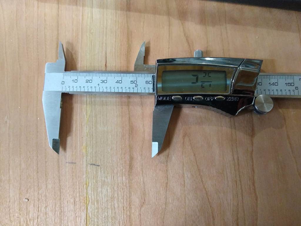Close-up of digital caliper showing precise measurement on a ruler