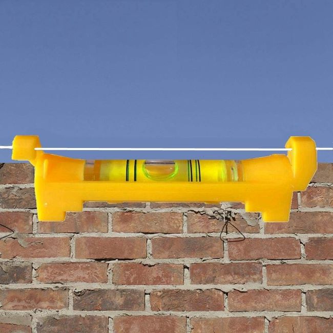 Yellow YOTOM hanging bubble line levels used for surveying and construction