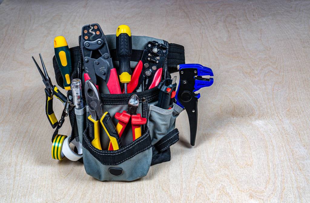 Professional electrician tools kit organized on workbench