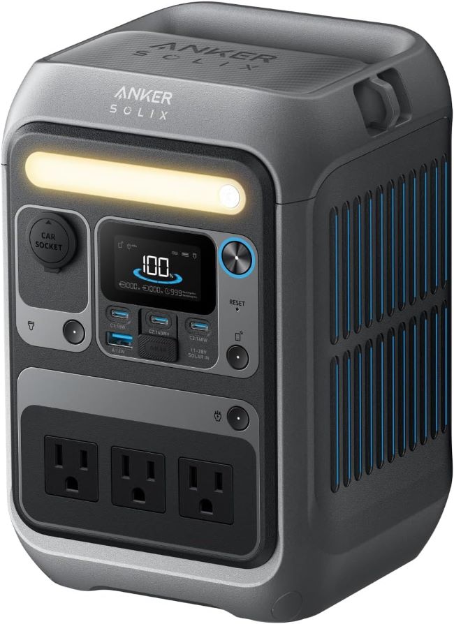 Anker SOLIX C300 portable power station powering phones and laptops during camping in Michigan