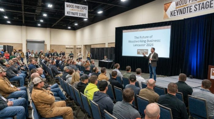 A speaker presenting a business education session to woodworking industry professionals at the Wood Pro Expo Lancaster 2026 keynote stage