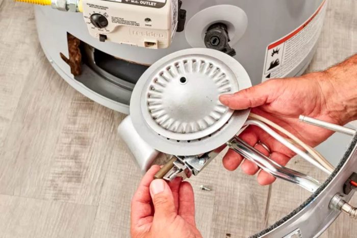 Inspecting copper safety thermocouple on Cuisinart propane burner assembly